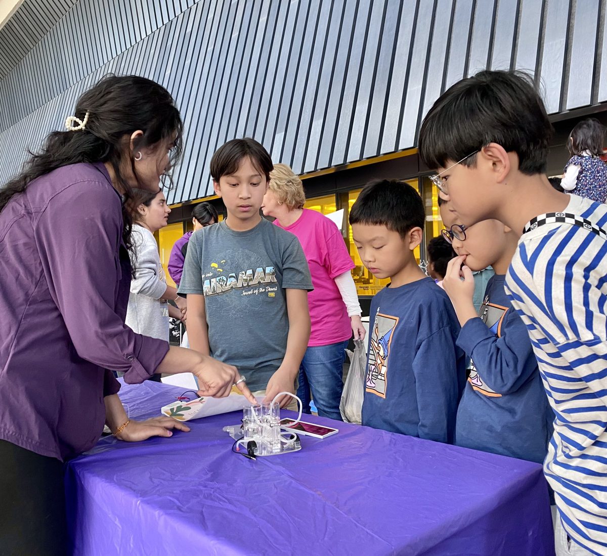 Showing young visitors how a solar-powered hydrogen fuel cell car works, at a Georgia Tech outreach event